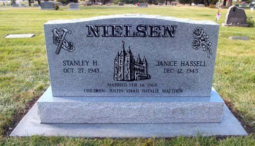 Gray gravestone in a cemetery engraved “Nellis” with a church image and two names.