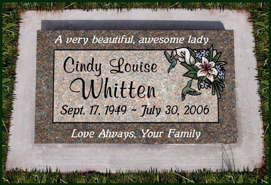 Memorial headstone with flowers, engraved “Cindy Louise Whitten” and dates Sept. 7, 1949–July 30, 2006.