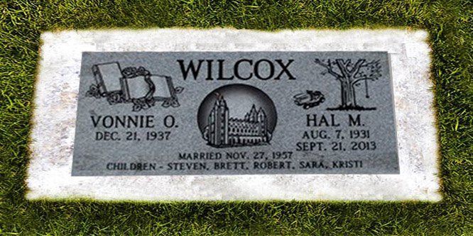 Gravestone with the name Wilcox and engraved family names, set in grass.
