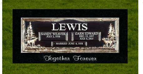 Black memorial plaque reading “LEWIS” with two name panels and “Together Forever” on green grass