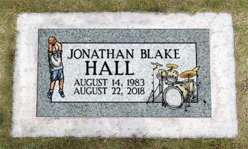 Gravestone for Jonathan Blake Hall with dates, decorated with a basketball player and drum set.