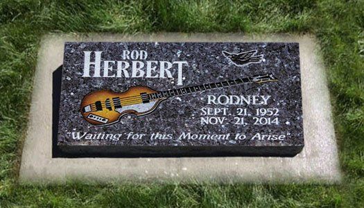 Gravestone plaque for Rod Herbert and Rodney with engraved text on black stone in grass