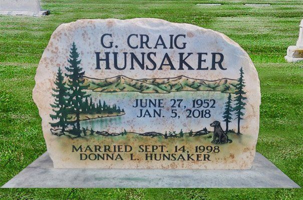 Gravestone for G. Craig Hunsaker with pine tree and mountain scene, showing dates June 27, 1952–Jan. 5, 2018.