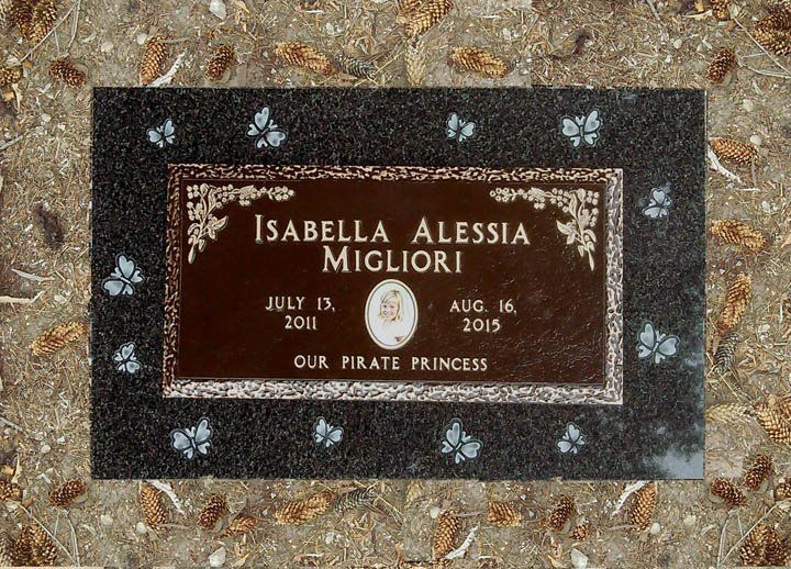 Memorial plaque for Isabella Alessia Migliori, July 13, 2010–Aug. 16, 2015, on stone ground