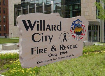 Willard City Fire & Rescue sign in front of a building, with grass and a city seal.