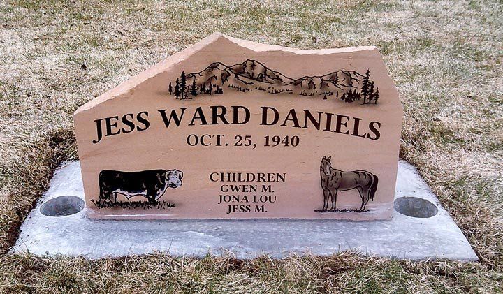 Gravestone for Jess Ward Daniels with engraved date Oct. 25, 1940 and a small cat-shaped cutout.