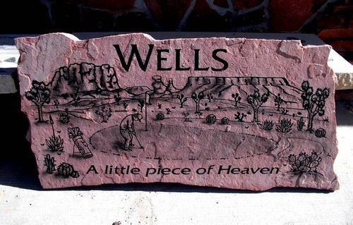 Pink stone plaque engraved “Wells” with a desert scene and the words “A little piece of Heaven”