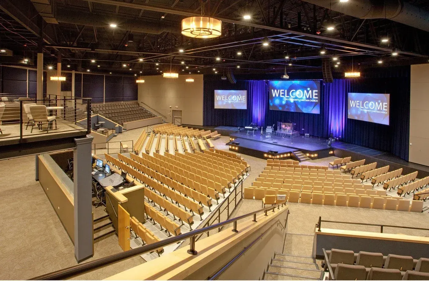 a large auditorium with a welcome sign on the stage