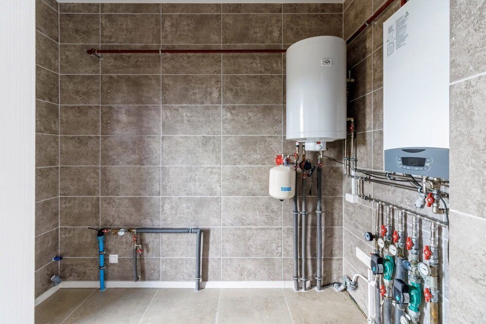 There Are Two Water Heaters In The Room — Bennett Plumbing In Broughton Village, NSW