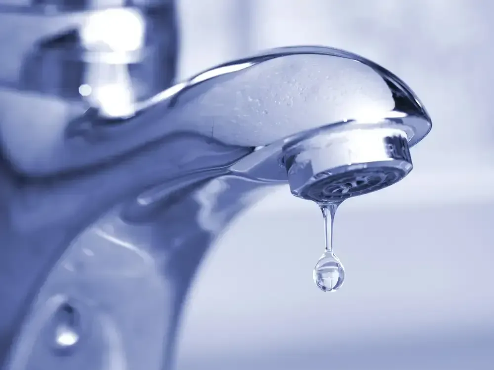 A Close Up Of A Water Faucet With A Drop Of Water Coming Out Of It — Bennett Plumbing In Broughton Village, NSW