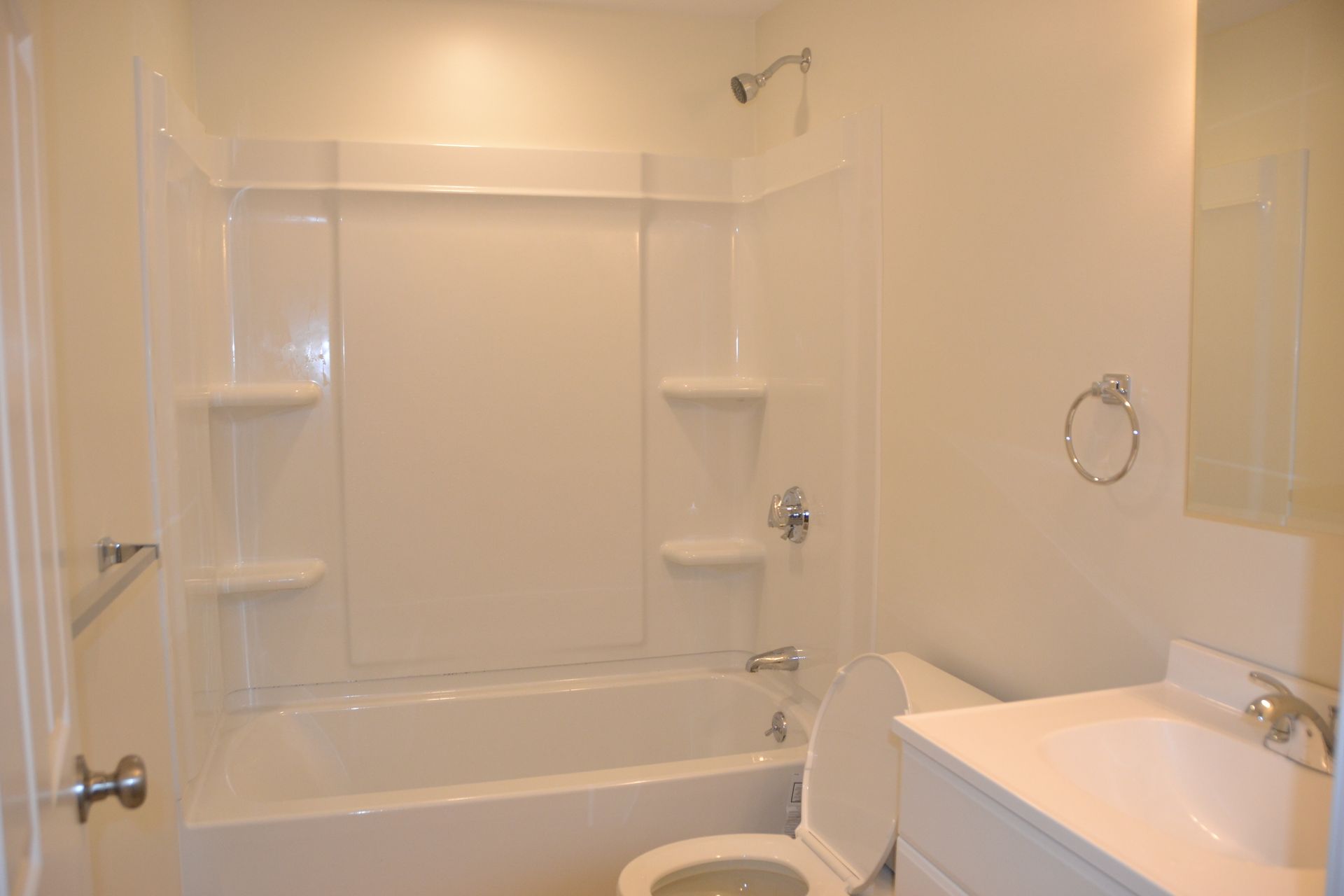 A bathroom with a toilet , sink , tub and shower.