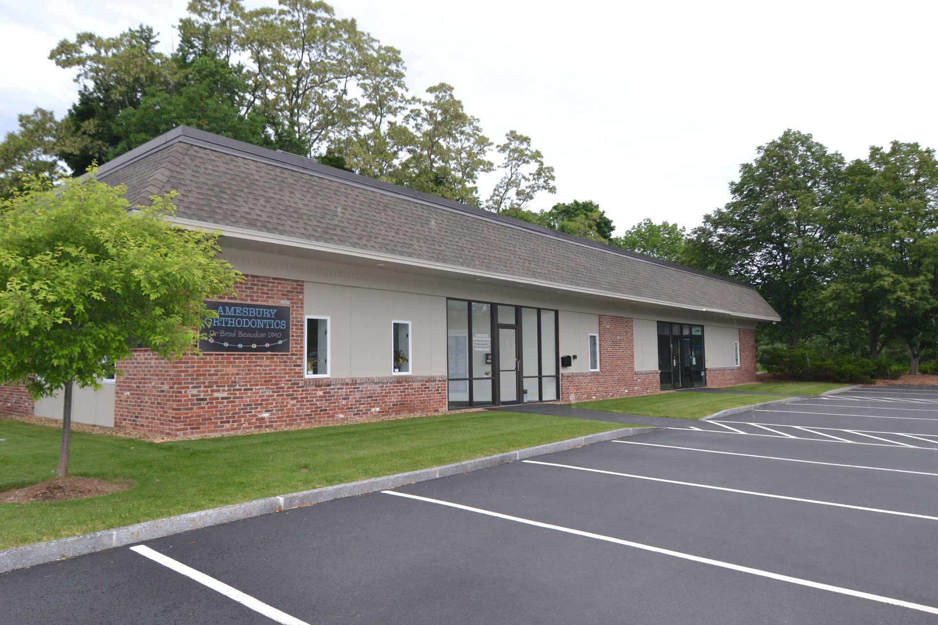 A small building with a parking lot in front of it
