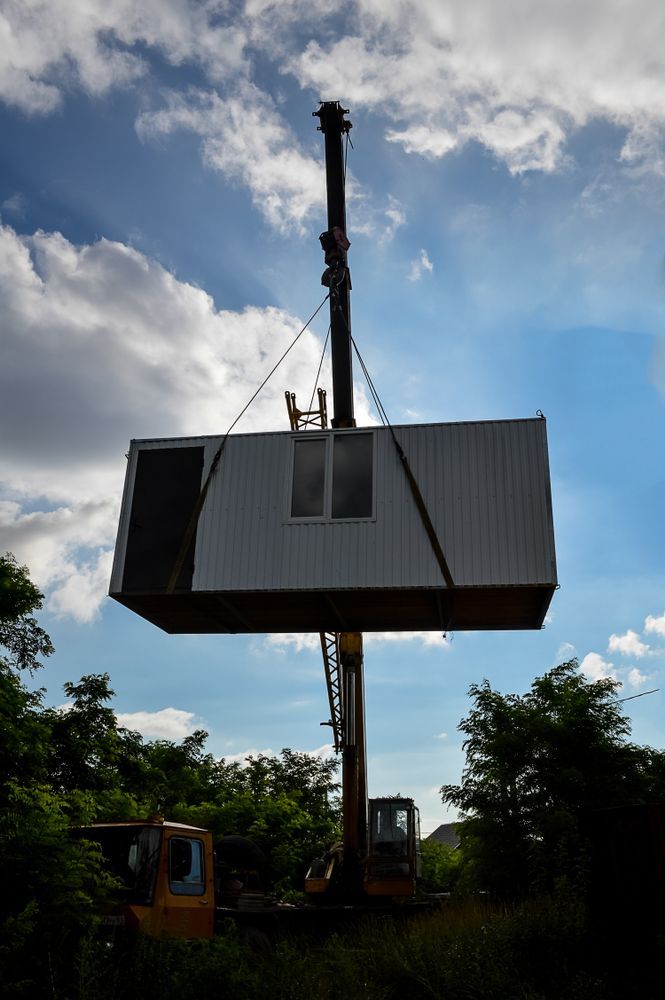 A Crane Is Lifting A Container Into The Air — All Lift Cranes In Nowra, NSW