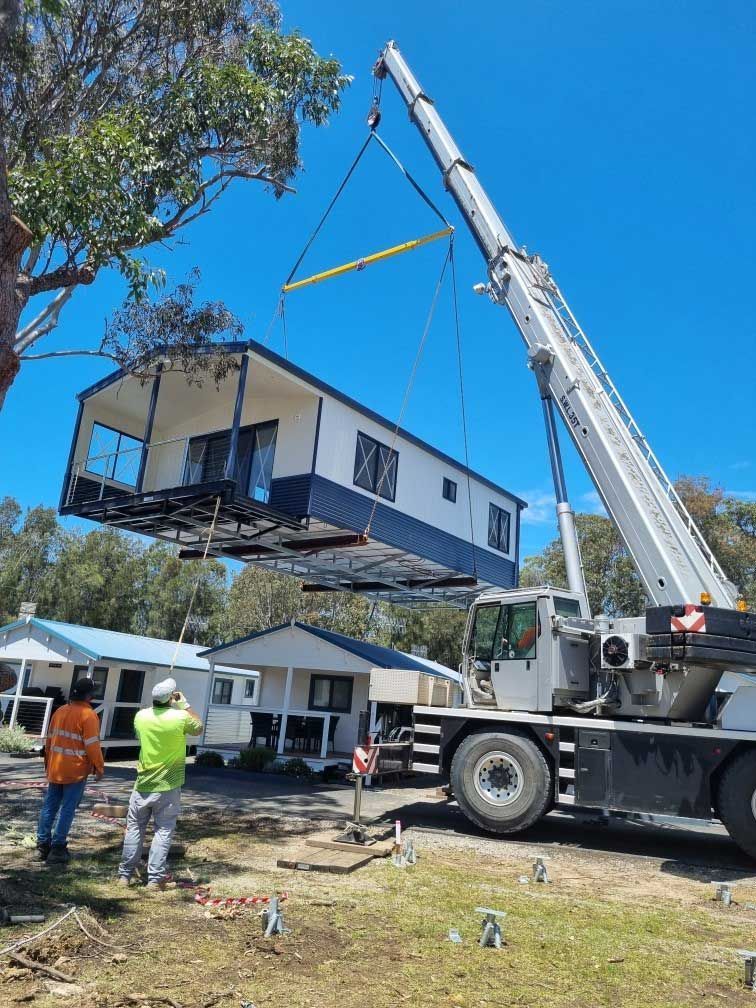 A Crane Is Lifting A House Into The Air — All Lift Cranes In St Georges Basin, NSW