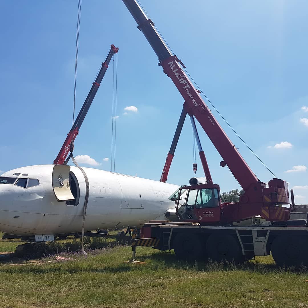 A Large White Airplane Is Being Lifted By A Crane — All Lift Cranes In Sussex Inlet, NSW
