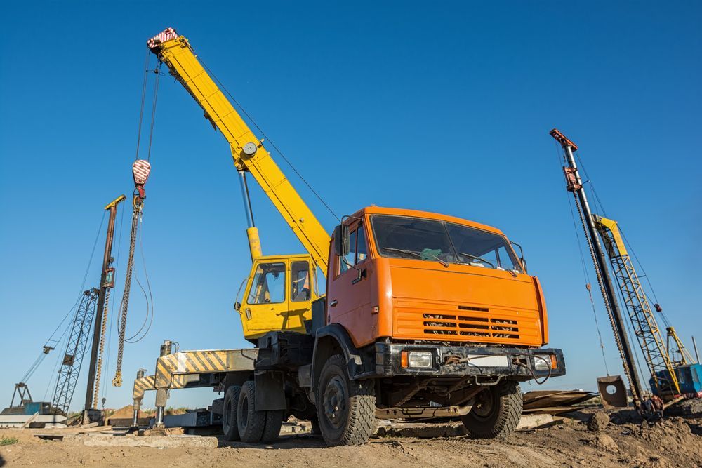 A Truck With A Crane Attached To It Is Parked On A Construction Site — All Lift Cranes In Vincentia, NSW