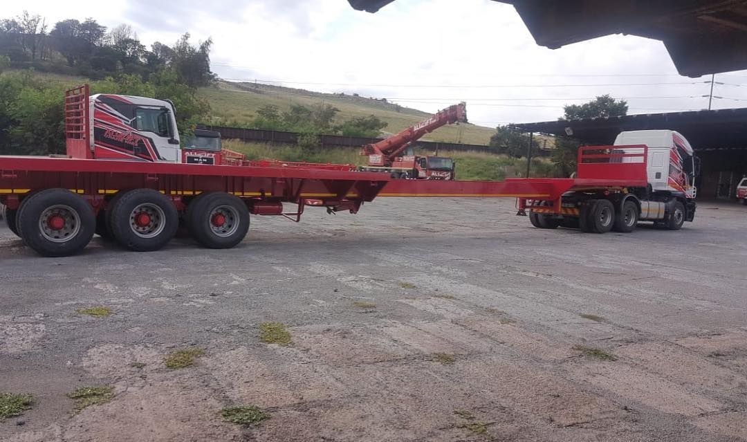 A Red Flatbed Truck Is Parked Beside Of The Road — All Lift Cranes In St Georges Basin, NSW