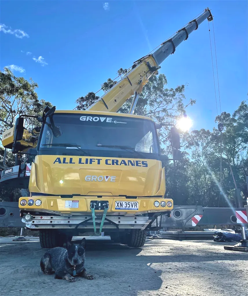 Yellow crane truck with raised boom, 