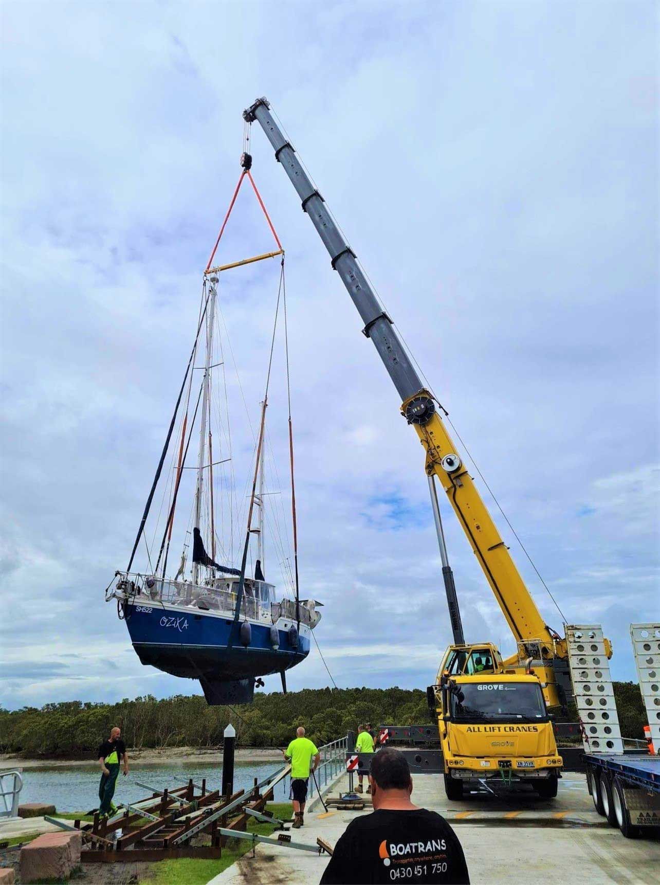 Yellow Crane Lifting a Boat