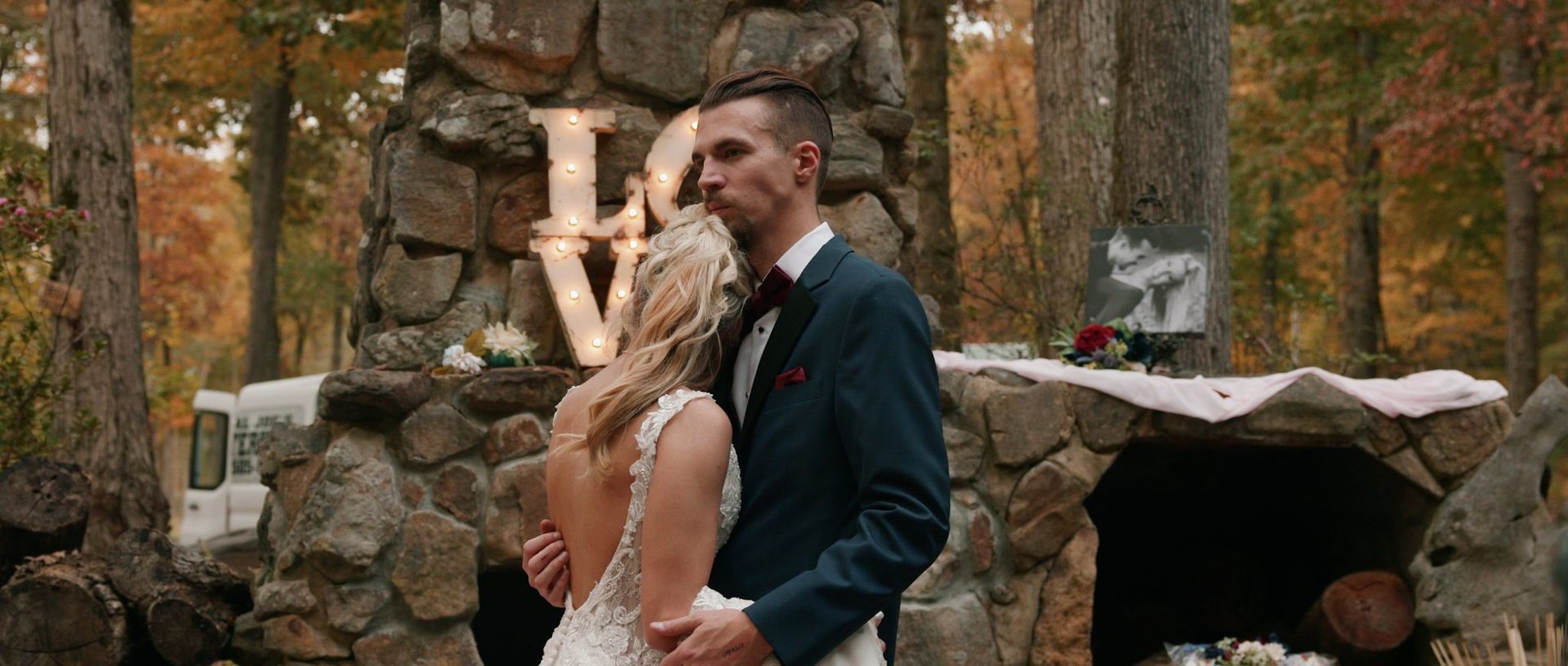 Bride and groom embracing, lit