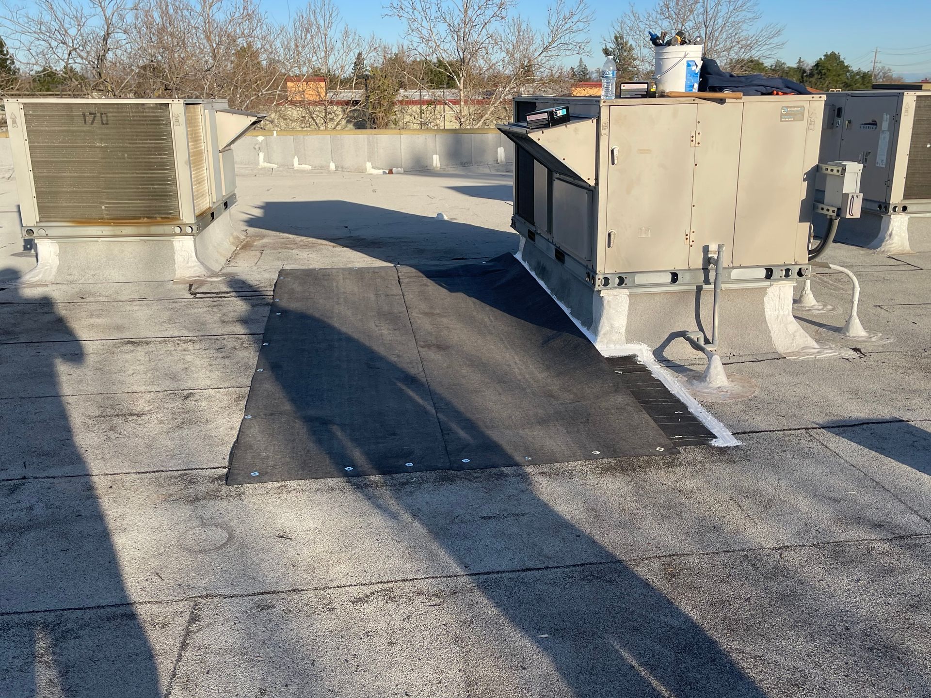 A roof with a lot of air conditioners on it