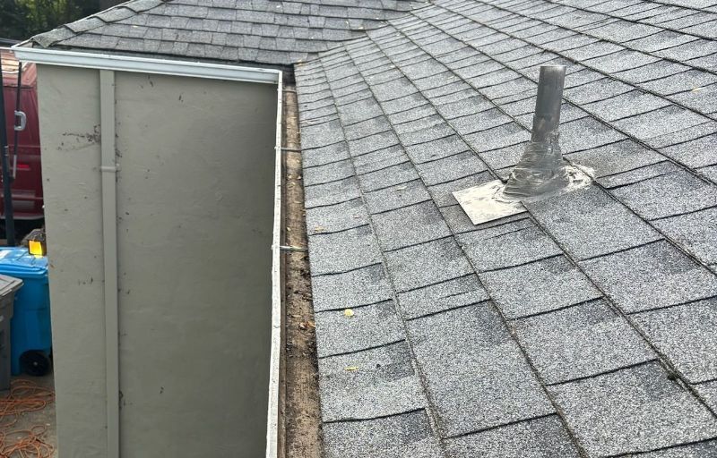 A roof with shingles and a chimney on it.