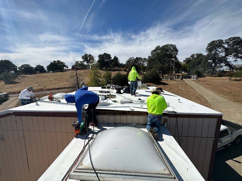 A group of people are working on the roof of a building.