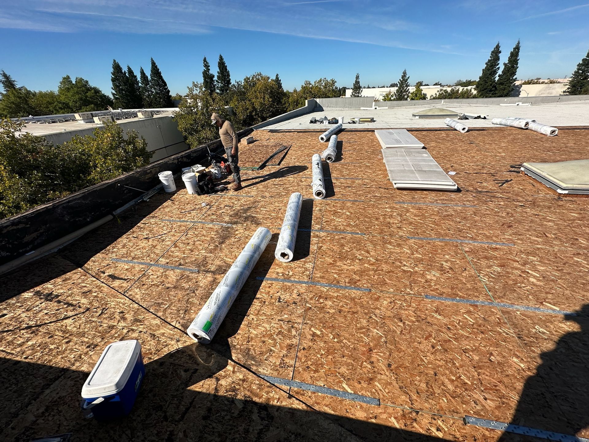 A man is standing on the roof of a building.