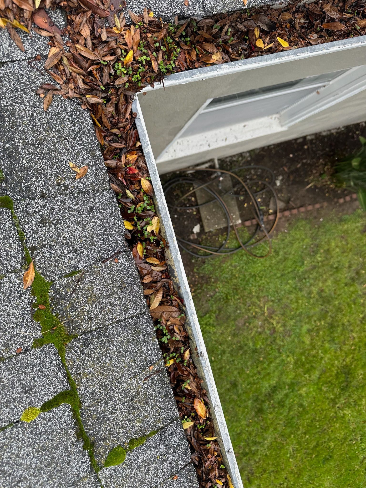 An aerial view of damaged roof shingles.