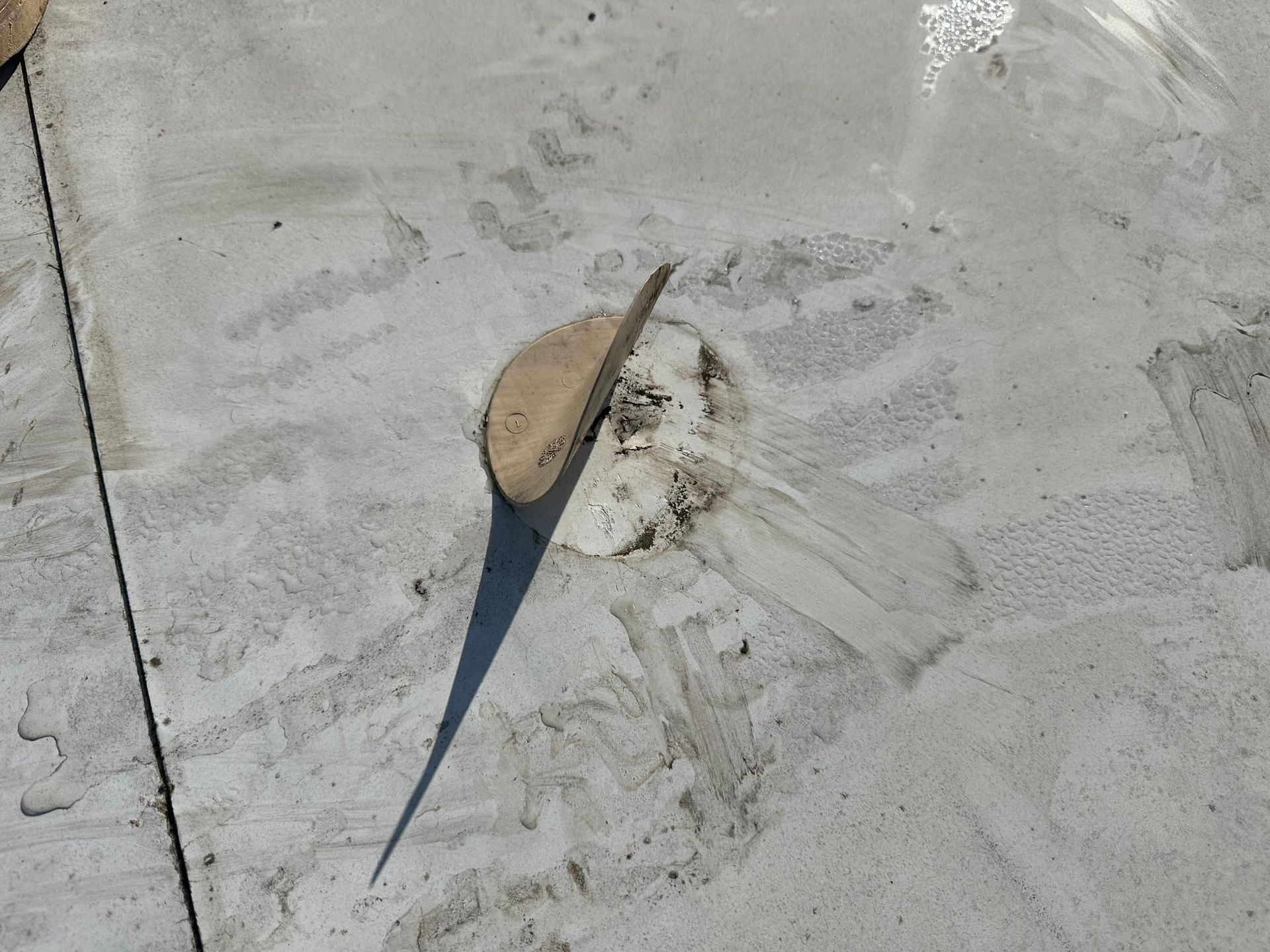 A concrete surface with a shadow of a clock on it