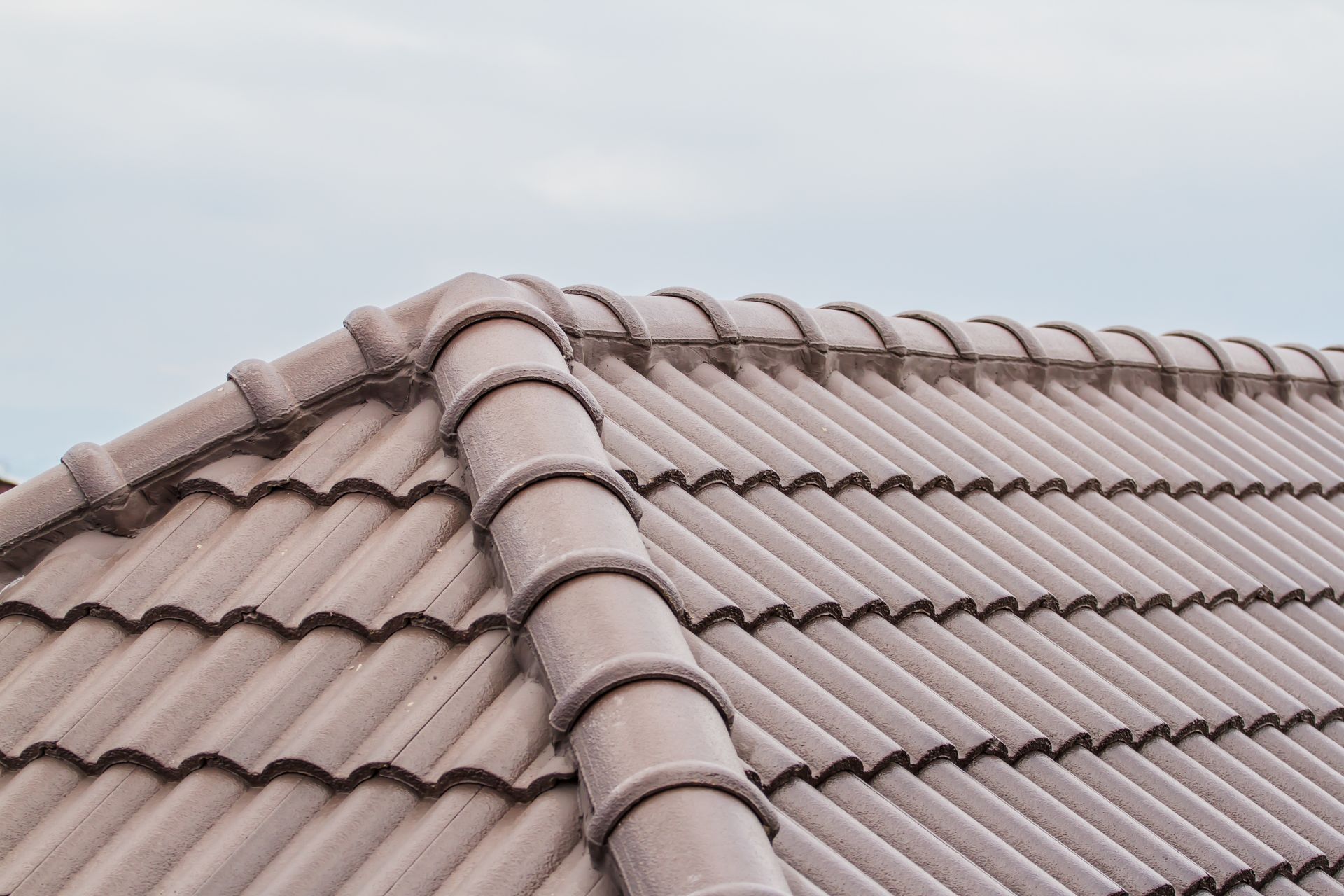 A close up of a roof with a blue sky in the background.