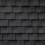 Dark gray shingle roof close-up, showing overlapping rectangular tiles.