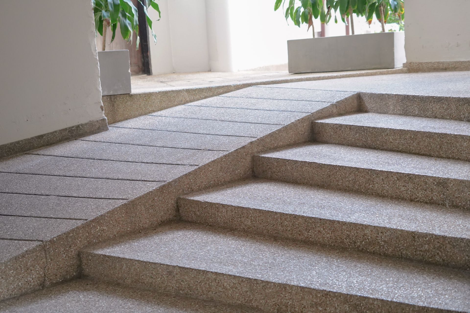 Stone stairs and a ramp for accessibility, indoors.