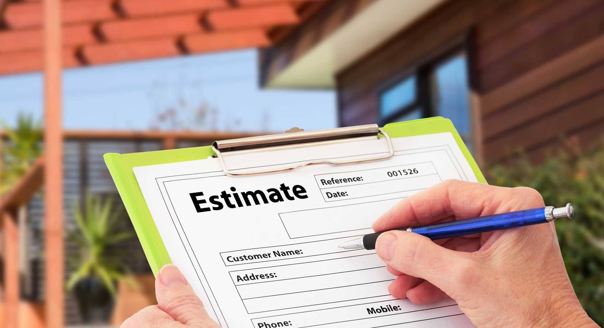 A person is writing on a clipboard with the word estimate on it.