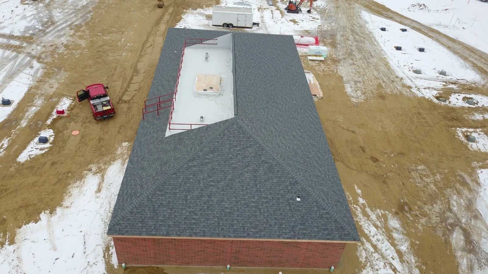 An aerial view of a building under construction in the snow. An aerial view of a building under construction in the snow.