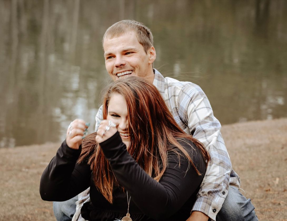 Husband hugging wife from behind during an outdoor couple's portrait session – Shine Again Photography Newnan GA