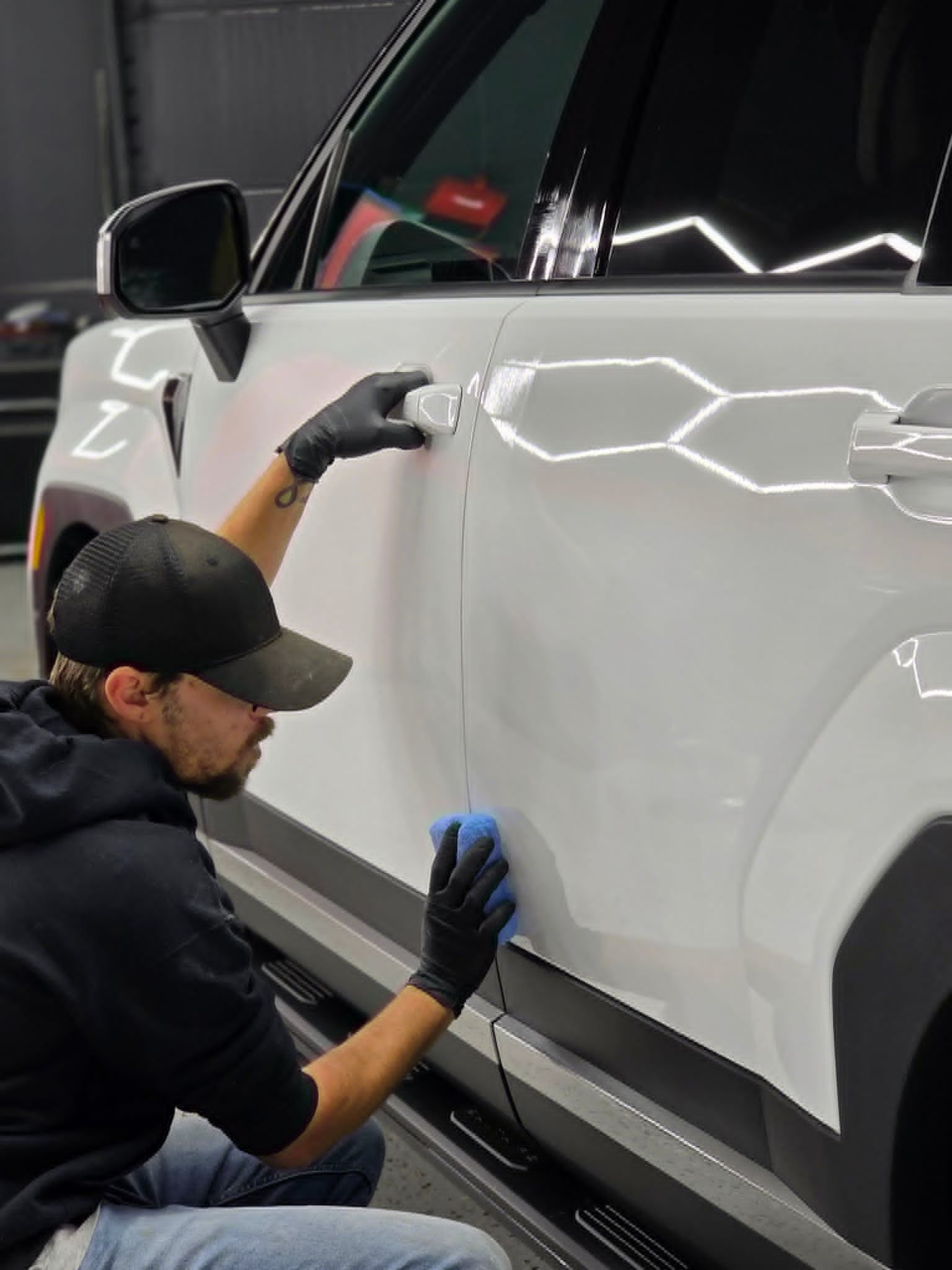 Auto detailer preparing vehicle surface for ceramic coating in Newnan GA - Shine Again Photography branding portrait