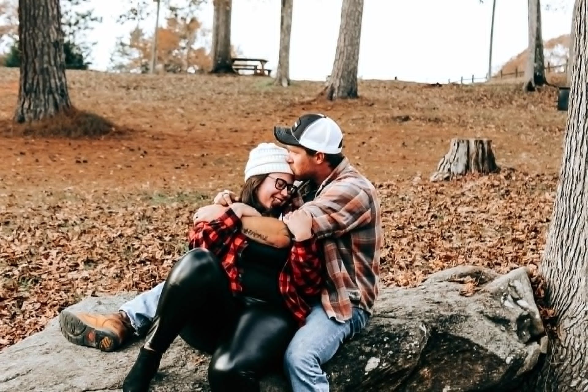 Couple sitting together outdoors in the forest – Shine Again Photography couples session in Newnan GA