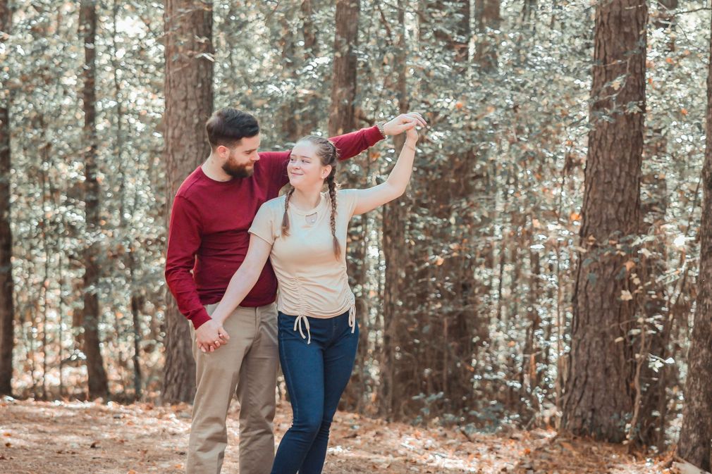 Newnan GA engagement photographer capturing a happy couple outdoors during a golden hour portrait session