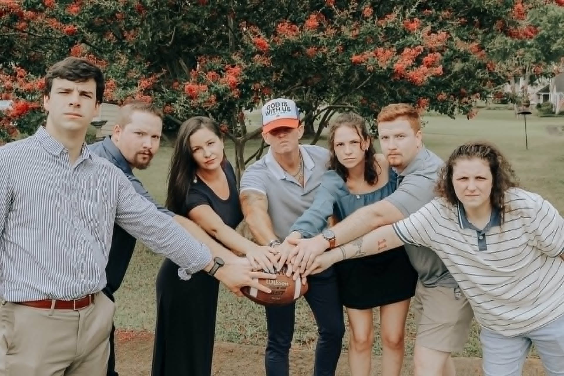 Large family group photo session outdoors in a grassy field in Newnan, GA.