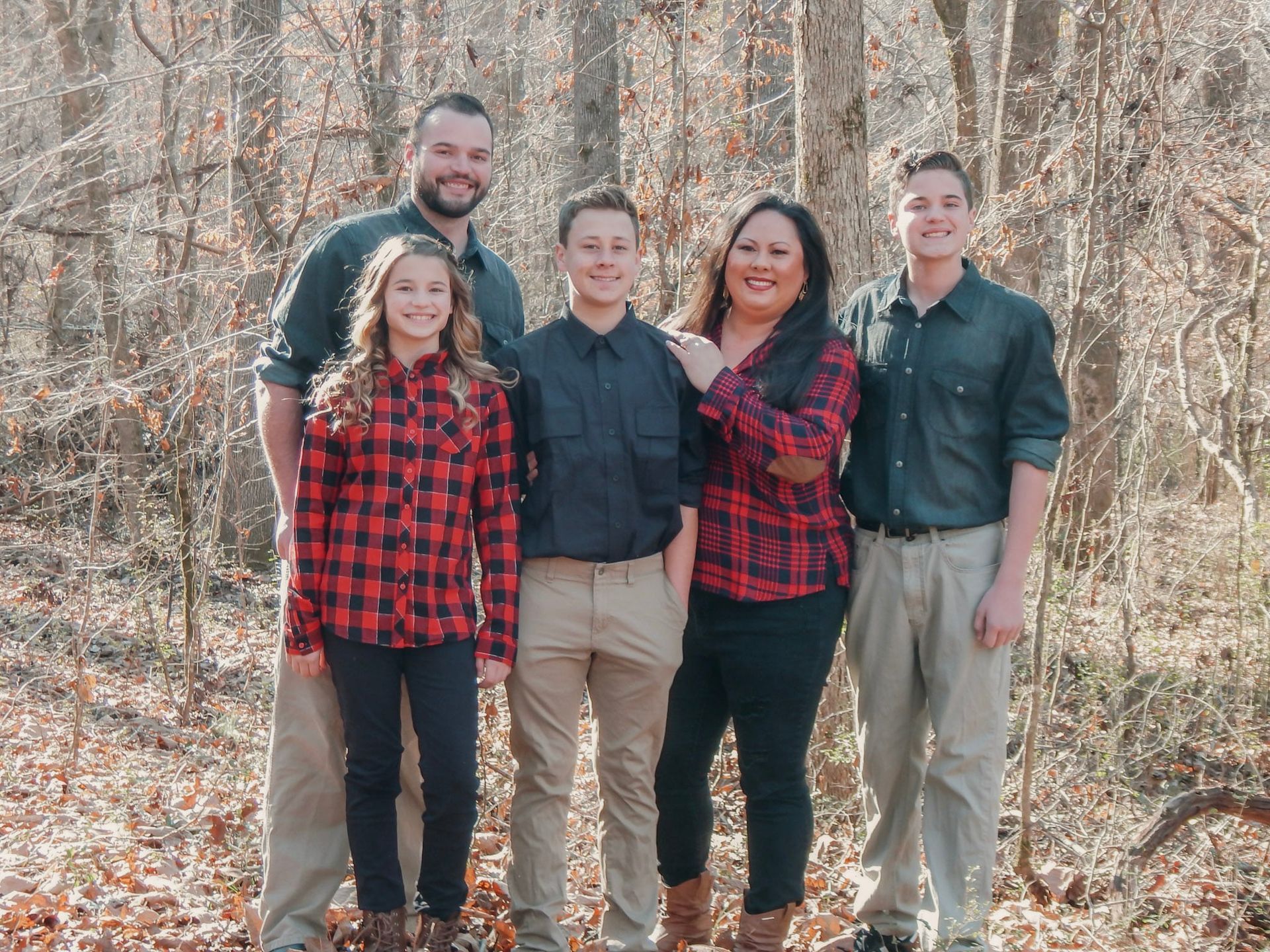 Family portrait of five people standing together outdoors in Newnan, GA.