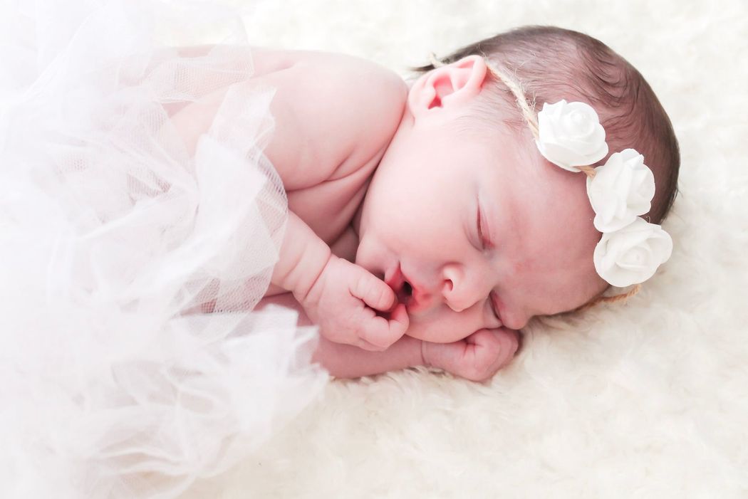 Sleeping newborn baby in white blanket with bow headband – Shine Again Photography Newnan GA