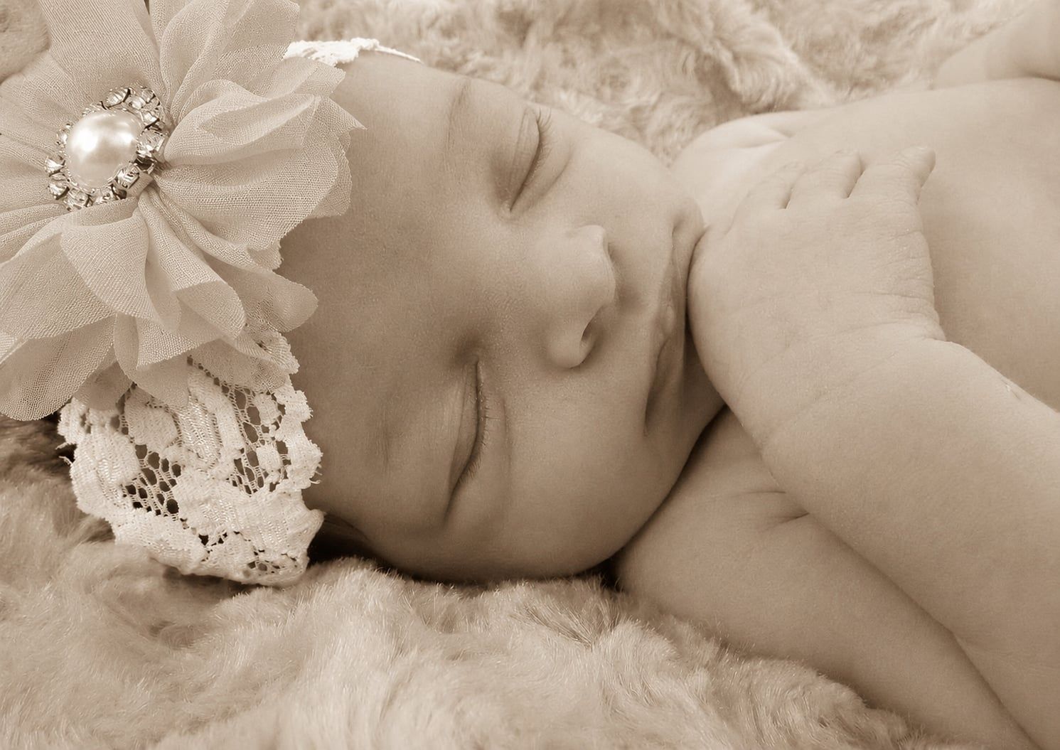 Close-up of sleeping newborn baby wearing floral jewel headband – Shine Again Photography Newnan GA