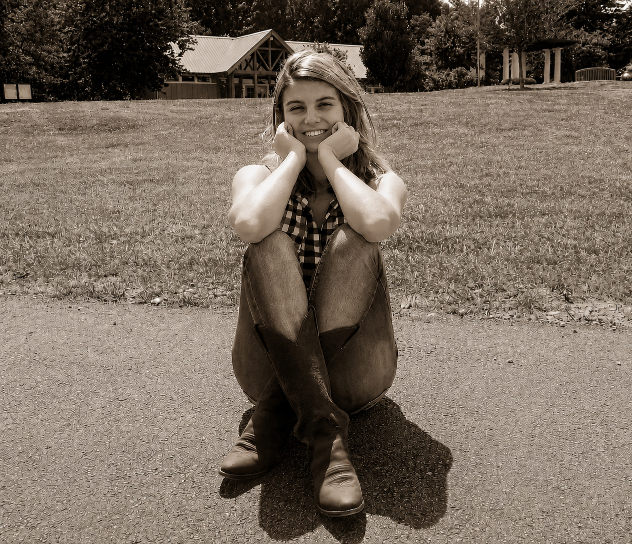Smiling high school senior sitting on the ground outdoors – Shine Again Photography Newnan GA