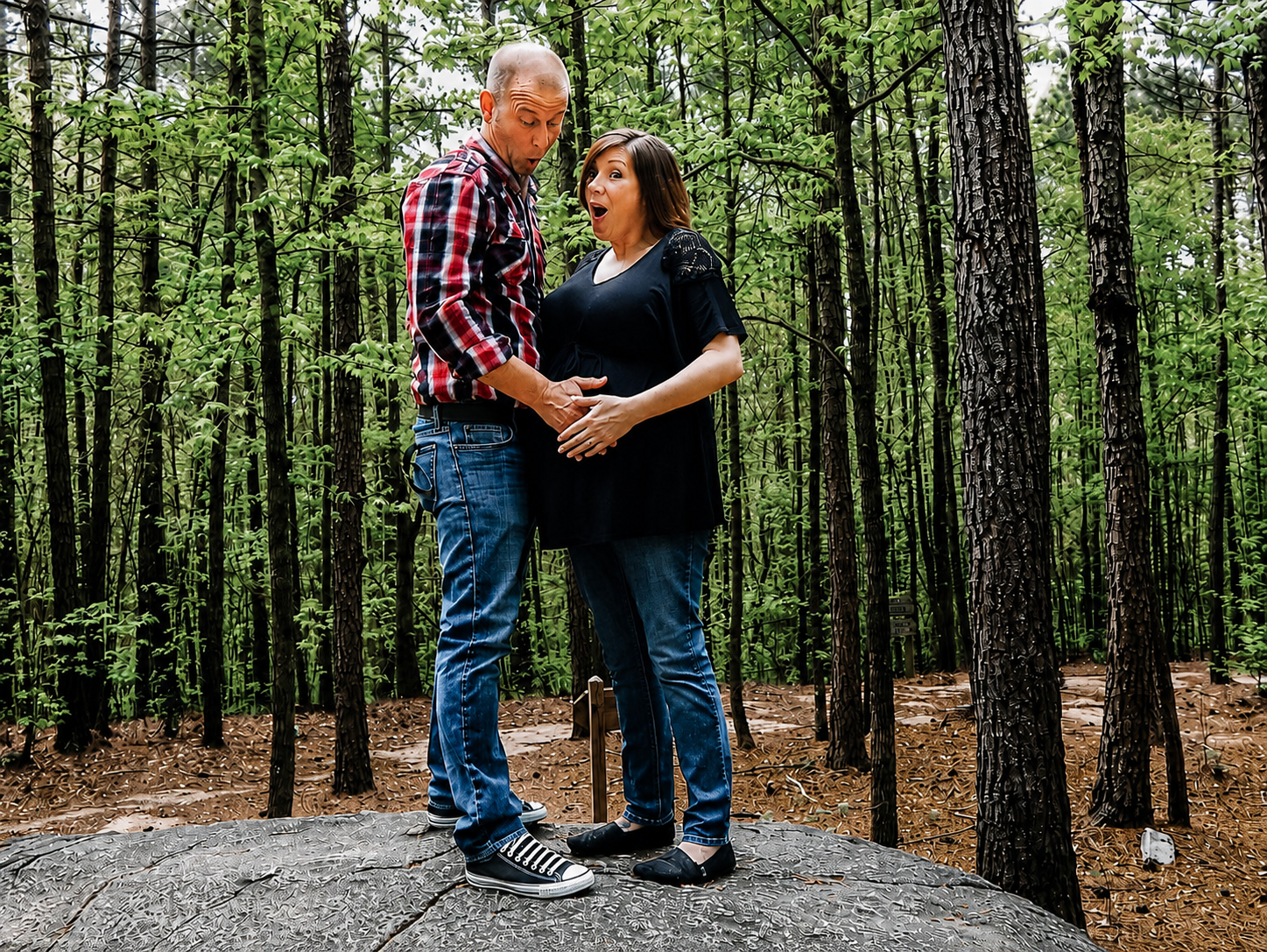 Expectant couple embracing outdoors in a forest during a maternity photo session – Shine Again Photography Newnan GA