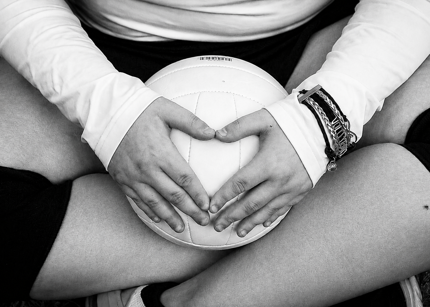 High school senior holding a volleyball with hands forming a heart shape – Shine Again Photography Newnan GA