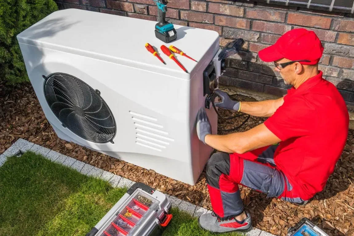 HVAC specialist inspecting large industrial rooftop cooling units.