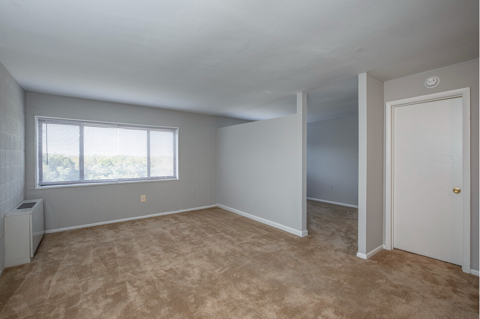 Studio living area with half wall divider to bed area.