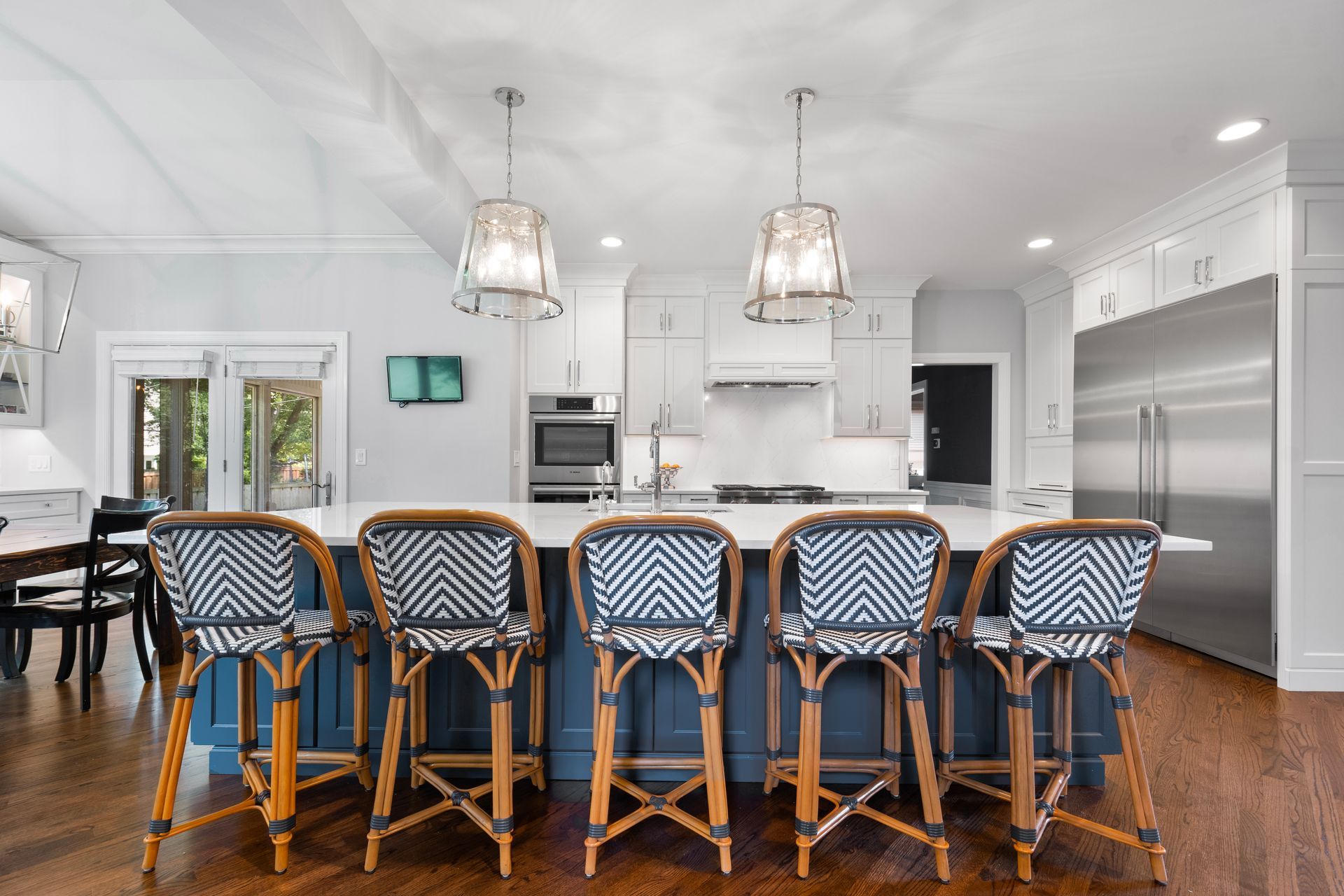 A kitchen with a large island and stools