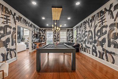 There is a pool table in the middle of the room.